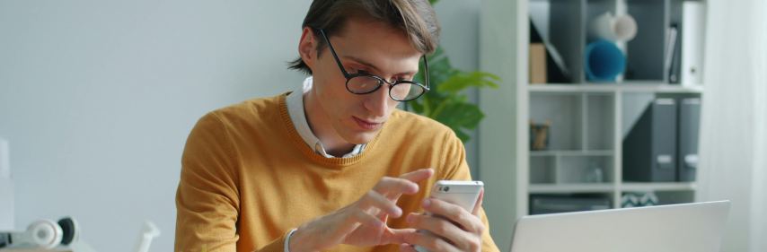 person on phone at a computer