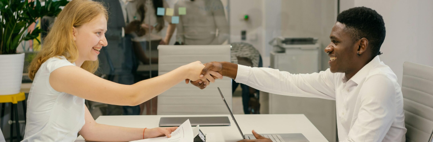business people shaking hands over a table